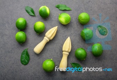 Fresh Limes And Wooden Juicer On White Background. Top View Stock Photo