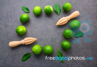 Fresh Limes And Wooden Juicer On White Background. Top View With… Stock Photo