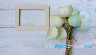 Fresh Lotus Flower Bouquet With Wood Frame On White Table Stock Photo