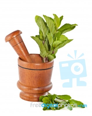 Fresh Mint Herb In Wooden Mortar With Pestle Stock Photo