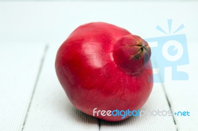 Fresh Pomegranate Fruit Isolated On A White Wooden Background Stock Photo