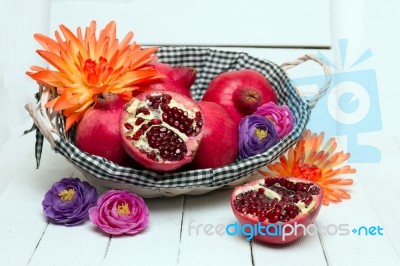 Fresh Pomegranate Fruits Isolated On A White Wooden Background Stock Photo