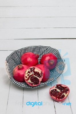 Fresh Pomegranate Fruits Isolated On A White Wooden Background Stock Photo