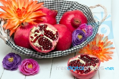 Fresh Pomegranate Fruits Isolated On A White Wooden Background Stock Photo