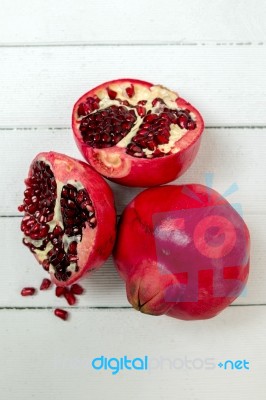 Fresh Pomegranate Fruits Isolated On A White Wooden Background Stock Photo