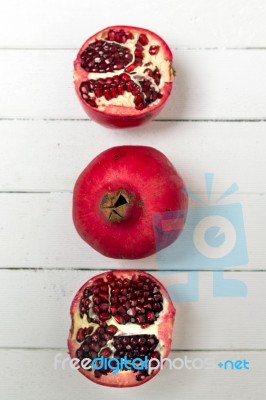 Fresh Pomegranate Fruits Isolated On A White Wooden Background Stock Photo