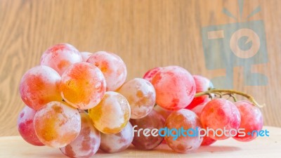 Fresh Red Grapes On Wooden Background Stock Photo