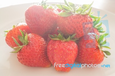 Fresh Ripe Strawberries On White Plate Stock Photo