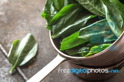 Fresh Spinach In The Copper Pot Stock Photo