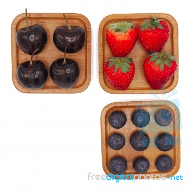 Fresh Summer Fruits, Cherry, Strawberry, And Blueberry In Wooden… Stock Photo