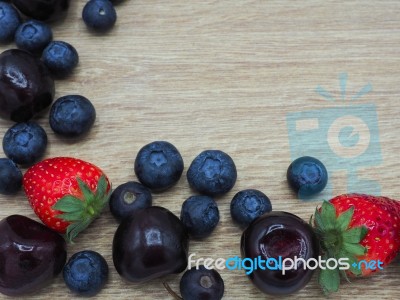 Fresh Summer Fruits, Cherry, Strawberry And Blueberry On Wood Ba… Stock Photo