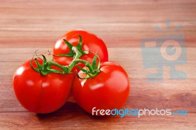 Fresh Three Of Tomato On Top Wood Table With Copy Space For Fill… Stock Photo