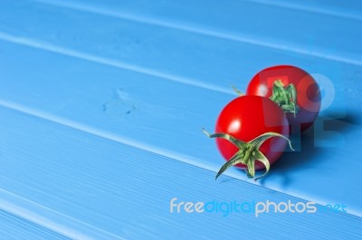 Fresh Tomatoes On The Blue Wooden Table Stock Photo