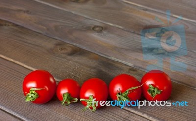 Fresh Tomatoes On The Dark Wooden Table Stock Photo