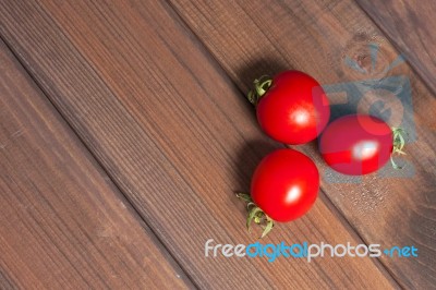 Fresh Tomatoes On The Dark Wooden Table Stock Photo