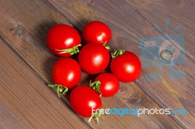 Fresh Tomatoes On The Dark Wooden Table Stock Photo