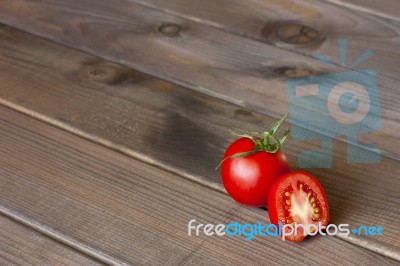 Fresh Tomatoes On The Dark Wooden Table Stock Photo