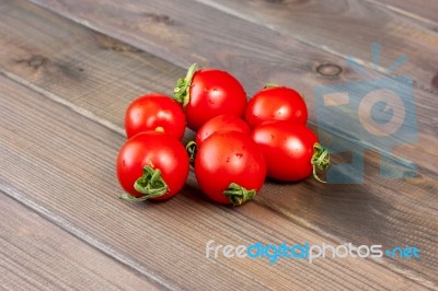 Fresh Tomatoes On The Dark Wooden Table Stock Photo