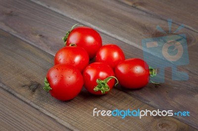 Fresh Tomatoes On The Dark Wooden Table Stock Photo