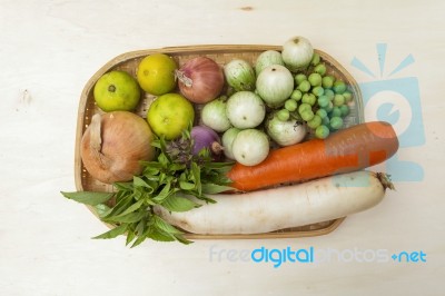 Fresh Vegetables In The Rattan Basket On Wood Background Stock Photo