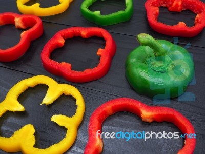 Fresh Vegetables, Red, Yellow, Green Sweet Peppers On Dark Wood Stock Photo