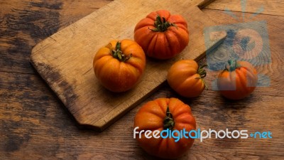 Freshly Picked Tomatoes, Place On Wooden Chopping Board And Table Stock Photo