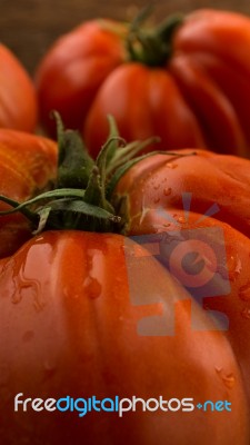 Freshly Picked Tomatoes, Place On Wooden Chopping Board And Table Stock Photo