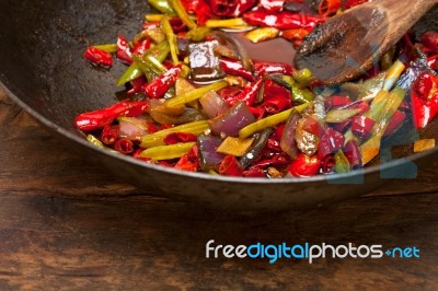 Fried Chili Pepper And Vegetable On A Wok Pan Stock Photo