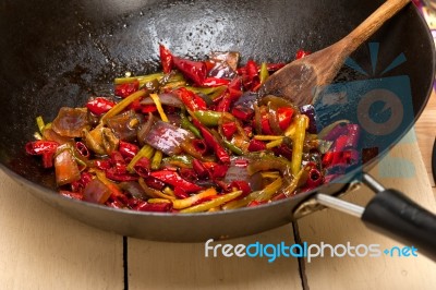 Fried Chili Pepper And Vegetable On A Wok Pan Stock Photo