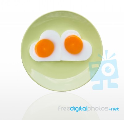 Fried Egg  Heart On Green Dish Stock Photo