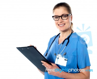 Friendly Female Doctor With A Clipboard Stock Photo