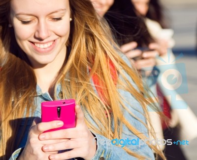 Friends Chatting With Their Smartphones Stock Photo