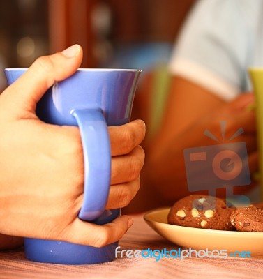 Friends Having Coffee And Cookies Stock Photo