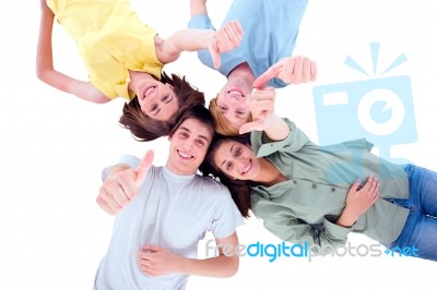 Friends Lying Down With Thumbs Up Stock Photo