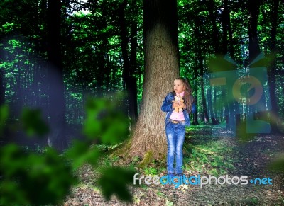 Frightened Little Girl In The Woods Stock Photo