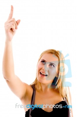 Front View Of Female Pointing Upward Stock Photo