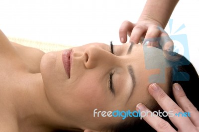 Front View Of Female Taking Head Massage Stock Photo