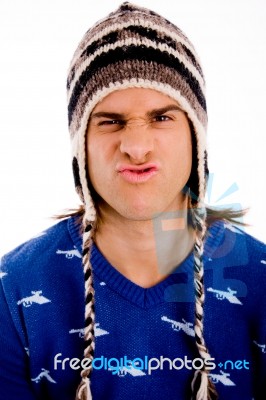 Front View Of Male Pulling Face And Wearing Cap Stock Photo