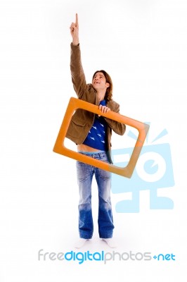 Front View Of Pointing Man Carrying Frame Stock Photo