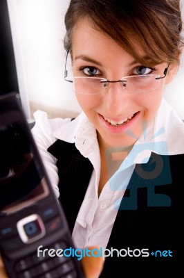 Front View Of Smiling Businesswoman Showing Her Cellphone Stock Photo