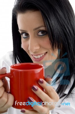 Front View Of Smiling Doctor Holding Mug On White Background Stock Photo