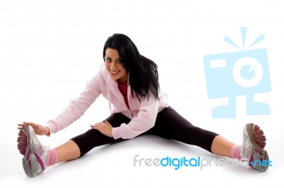 Front View Of Smiling Exercising Woman On White Background Stock Photo