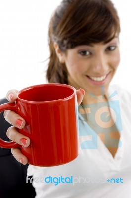 Front View Of Smiling Female Executive Holding Coffee Mug Stock Photo