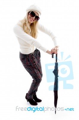 Front View Of Smiling Female Holding An Umbrella Stock Photo