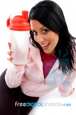 Front View Of Smiling Female With Bottle On White Background Stock Photo