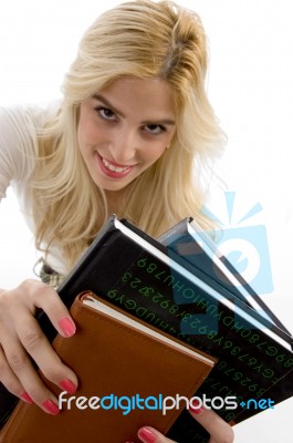 Front View Of Smiling Student Holding Course Books Stock Photo