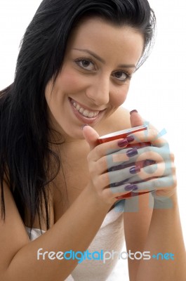 Front View Of Smiling Woman Holding Coffee Mug Stock Photo