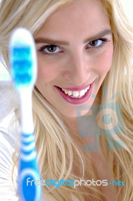 Front View Of Smiling Woman Holding Toothbrush Stock Photo