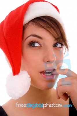 Front View Of Thinking Woman In Christmas Hat Stock Photo