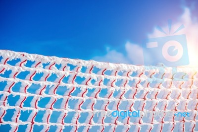 Frozen And Snow Covered Protective Net On Skiing Track. Concept Of Winter Stock Photo